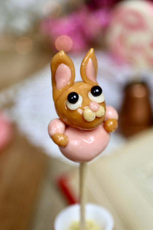 Sucette en forme de lapine en robe, couleurs caramel et framboise