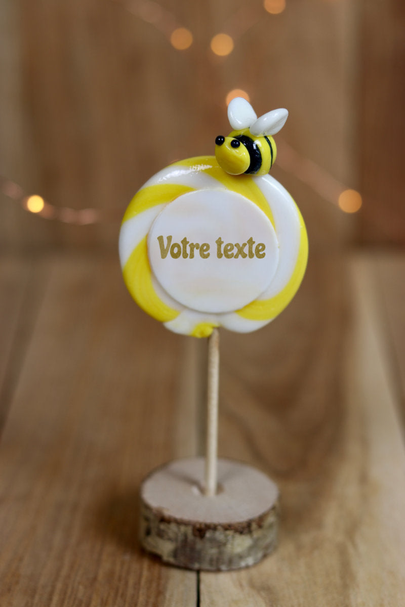 Sucette imprimée à personnaliser au citron avec une abeille sculptée dessus dans un décor féérique